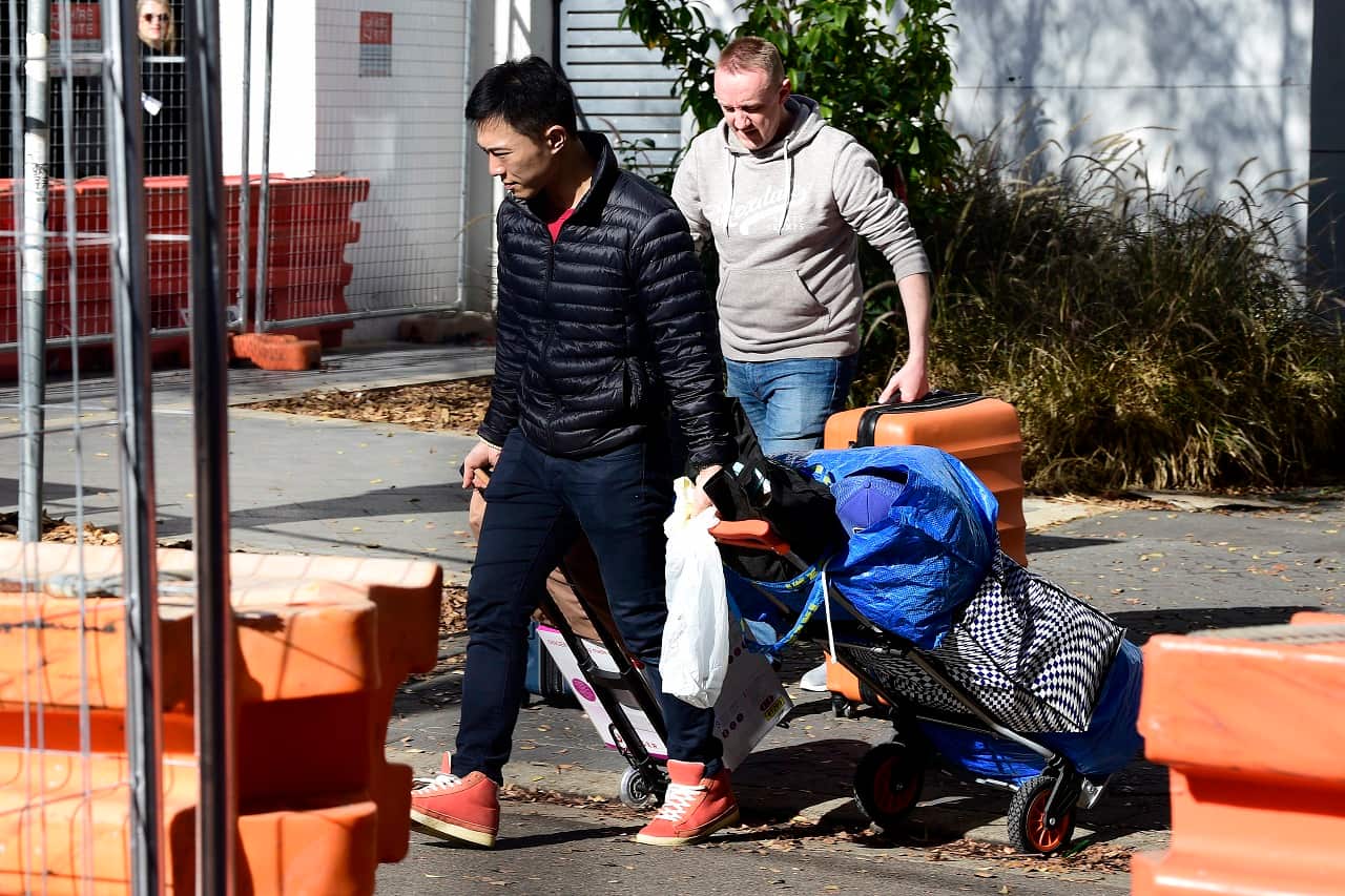 Mascot Towers residents collect their belongings.