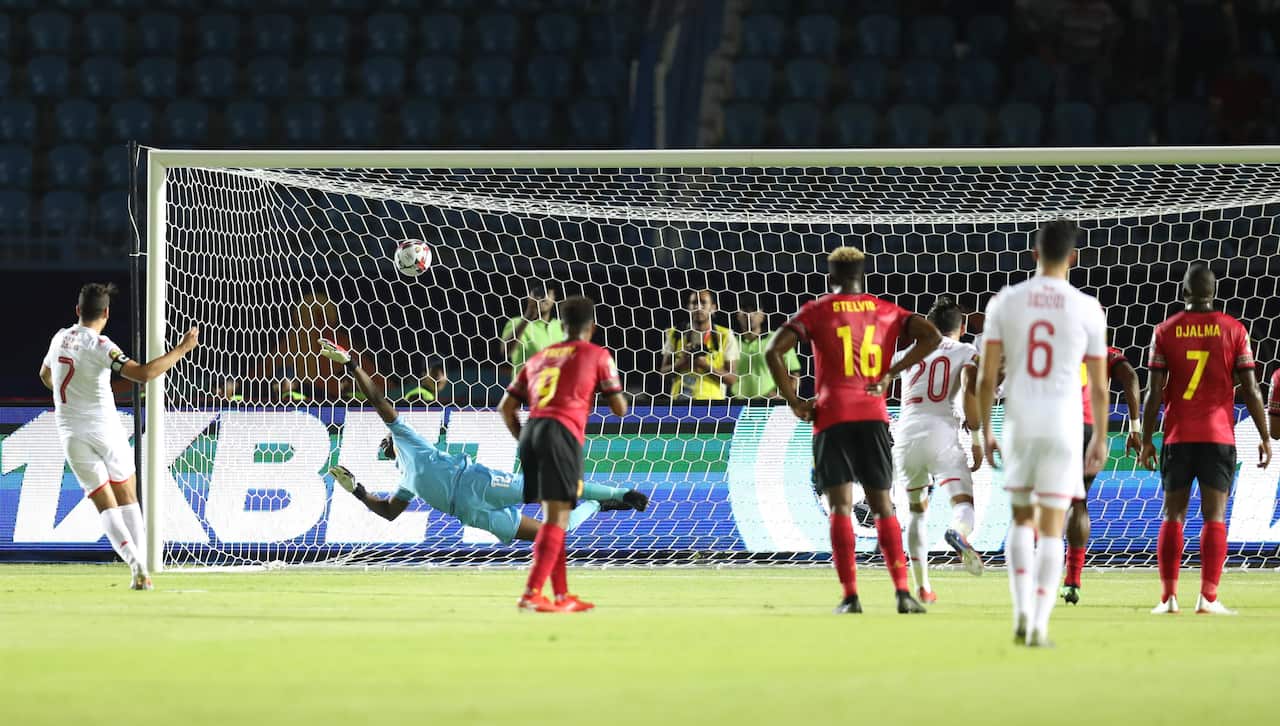 epa07671112 Youssef Msakni (L) of Tunisia scores on penalty during the 2019 Africa Cup of Nations Group E soccer match between Tunisia and Angola at Suez Army Stadium, Suez, Egypt, 24 June 2019.  EPA/Samuel Shivambu
