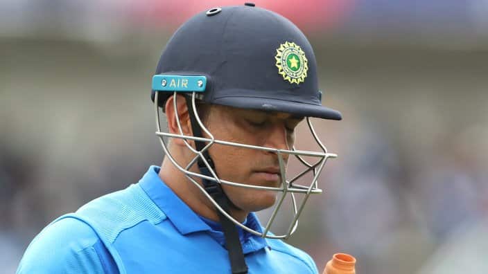 India's MS Dhoni reacts as he leaves the field after being dismissed by New Zealand's Martin Guptill during the Cricket World Cup semi-final match.