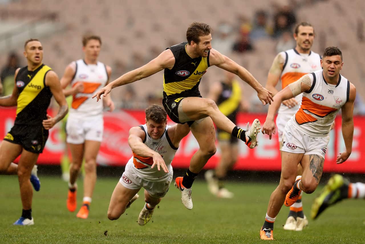 Kayne Lambert of the Tigers snaps for goal during the Round 17 AFL match between the Richmond Tigers and the GWS Giants at the MCG in Melbourne, Sunday, July 14, 2019. (AAP Image/Mark Dadswell) NO ARCHIVING, EDITORIAL USE ONLY