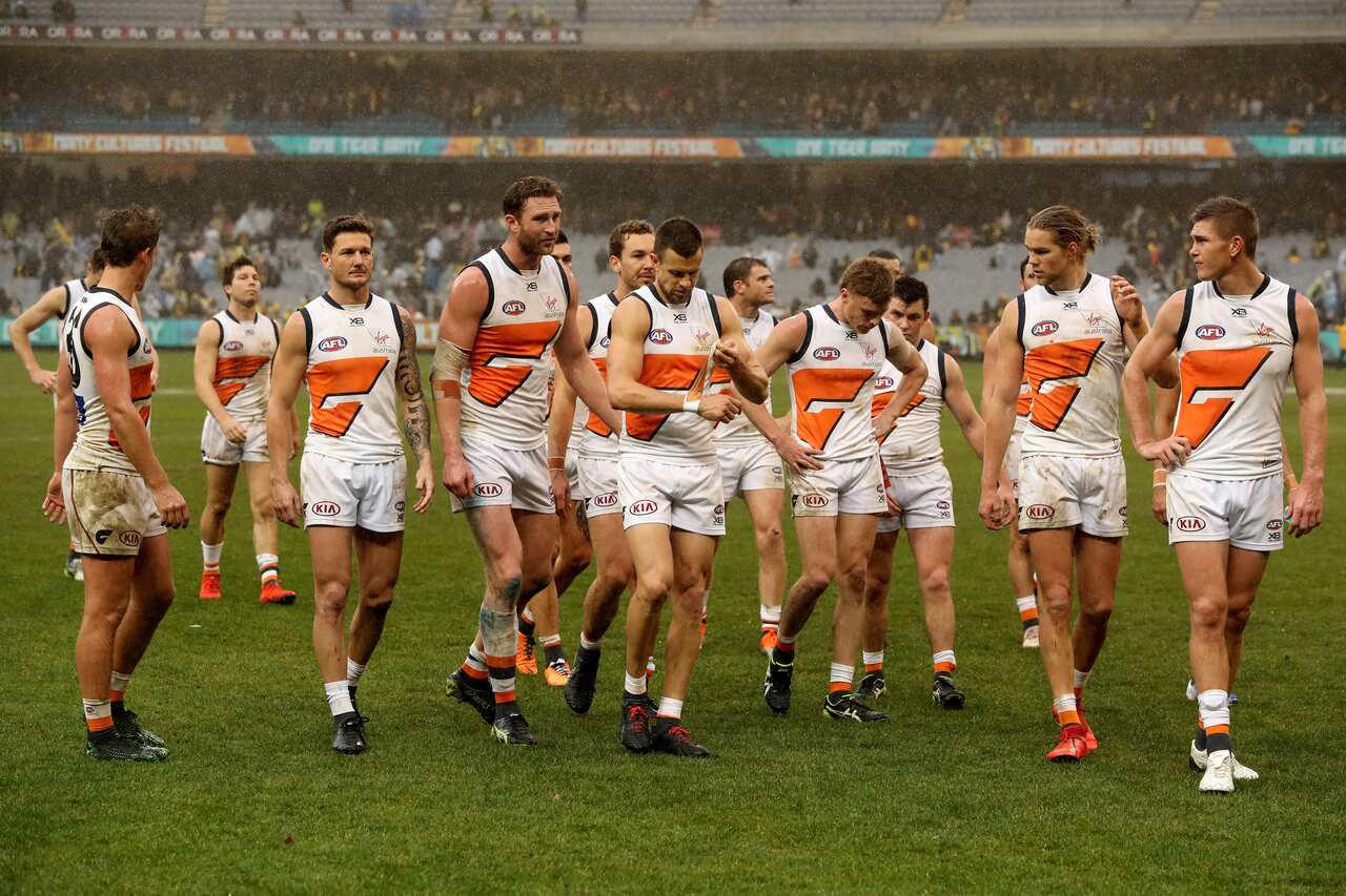 Giants players leave the ground after their loss in the Round 17 AFL match between the Richmond Tigers and the GWS Giants at the MCG in Melbourne, Sunday, July 14, 2019. (AAP Image/Mark Dadswell) NO ARCHIVING, EDITORIAL USE ONLY