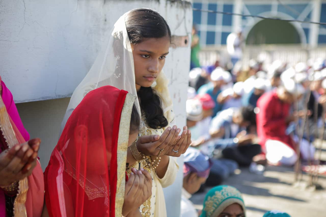 A Muslim woman prays at the Takiya Jame mosque during the celebration.