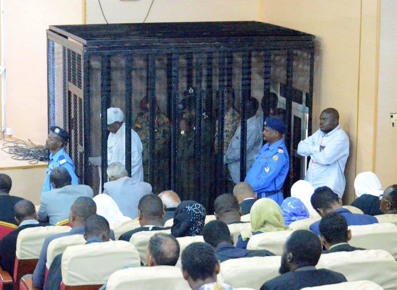  Sudan's ousted president Omar Hassan al-Bashir stands in a cage during his trial at a courtroom in Khartoum, Sudan