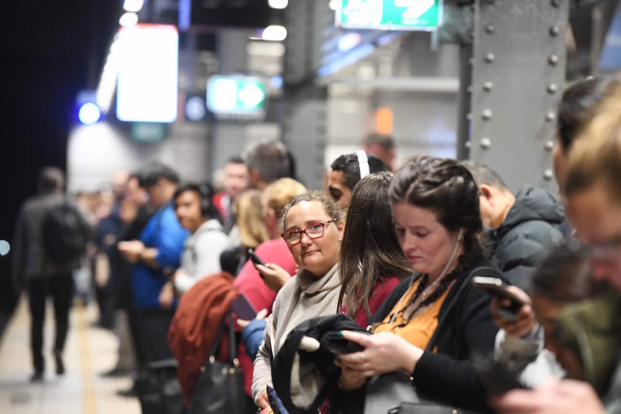Commuters are seen at Town Hall train station in Sydney, Friday, August 23, 2019. A train breakdown at Town Hall station is causing delays on the network. (AAP Image/Peter Rae) NO ARCHIVING
