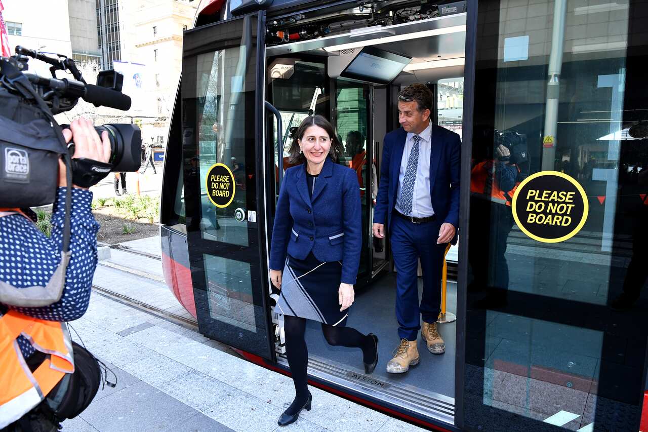 NSW Premier Gladys Berejiklian and NSW Minister for Transport Andrew Constance disembark after riding on the first light rail vehicle test from Town Hall to Circular Quay in Sydney, Wednesday, August 28, 2019. (AAP Image/Joel Carrett) NO ARCHIVING