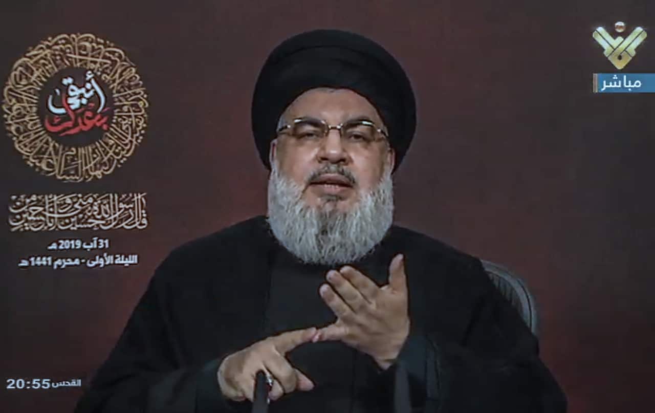 A handout vidoe grab made available by Hezbollah's al-Manar TV shows Hezbollah leader Sayed Hassan Nasrallah giving a speech during the inauguration of the Central Ashura Council on the first night of the month of Muharram 1441 AH, at Sayed al-Shuhada Com