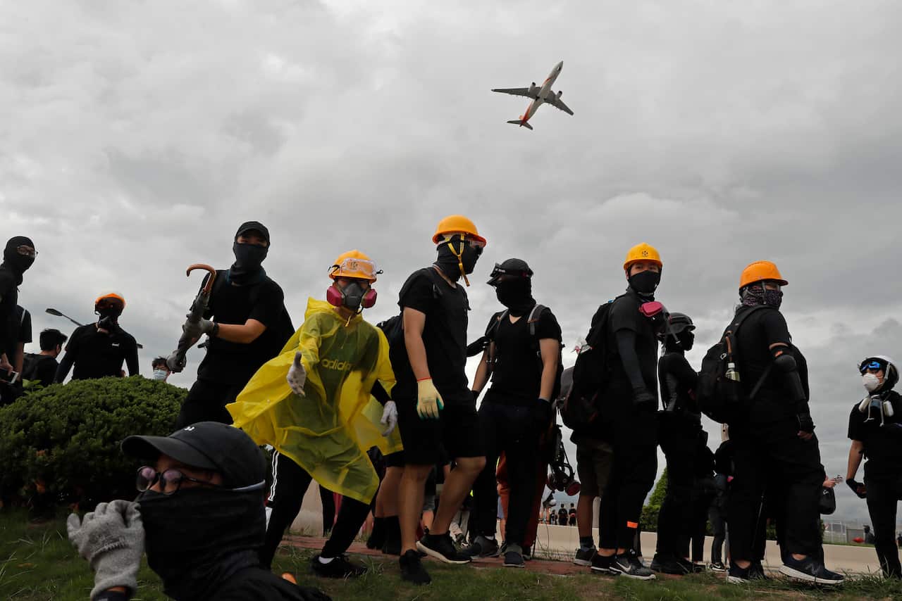 Pro-democracy protestors stand outside the airport in Hong Kong