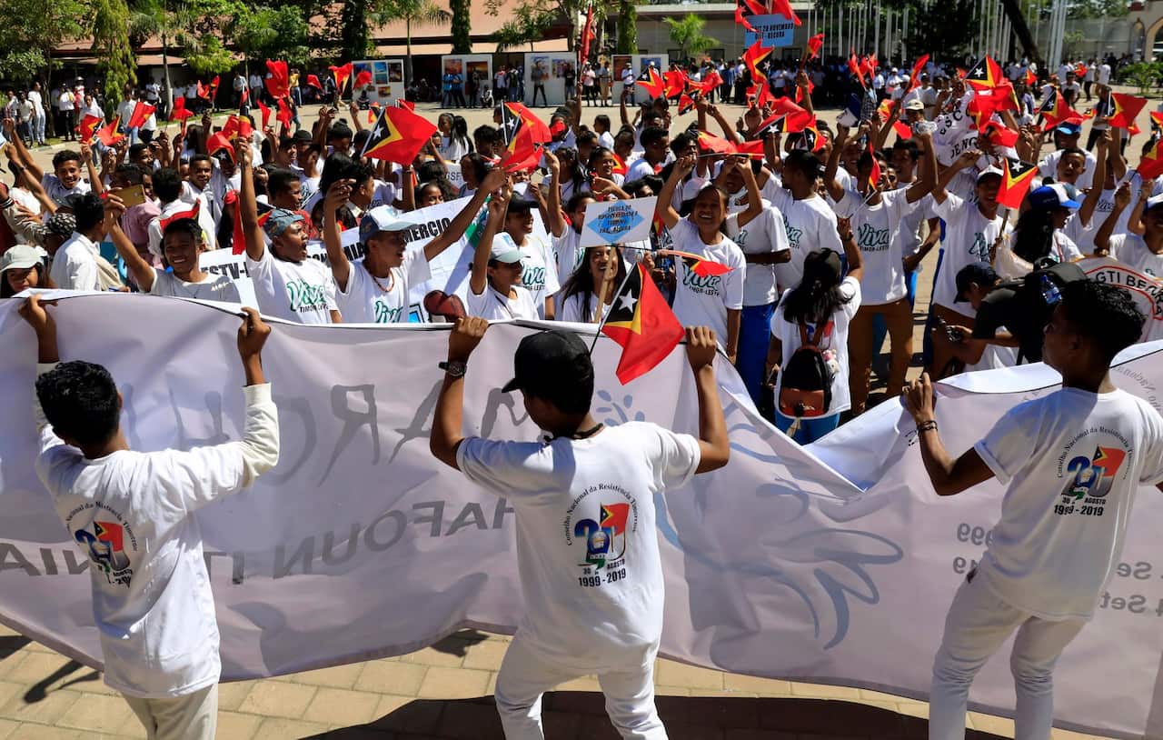 Students march during a parade to promote peace to mark the 20th anniversary of the referendum