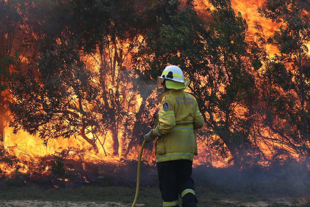 Firefighters battle bushfires in Angourie, northern New South Wales, Tuesday, September 10, 2019. (AAP Image/Jason O'Brien) NO ARCHIVING
