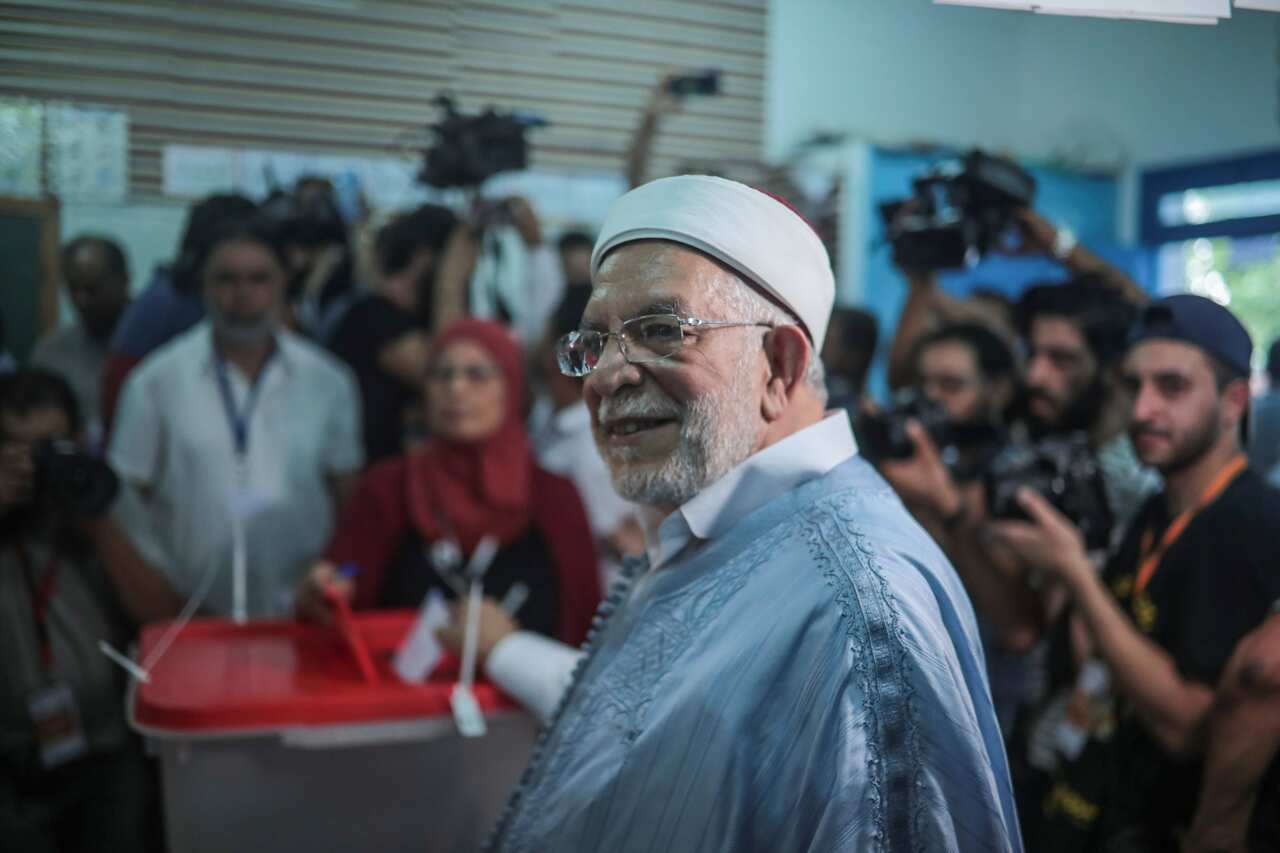 Ennahdha's presidential candidate Abdelfattah Mourou poses for journalists as he casts his ballot inside a polling station