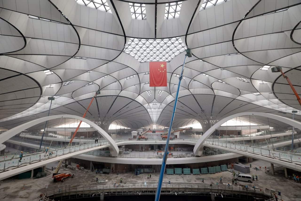 Chinese workers work inside the terminal hall of the new Beijing Daxing International Airport in Beijing, China, 01 March 2019 (reissued 25 September 2019). China's new airport has formally opened. The Beijing Daxing International Airport which is located