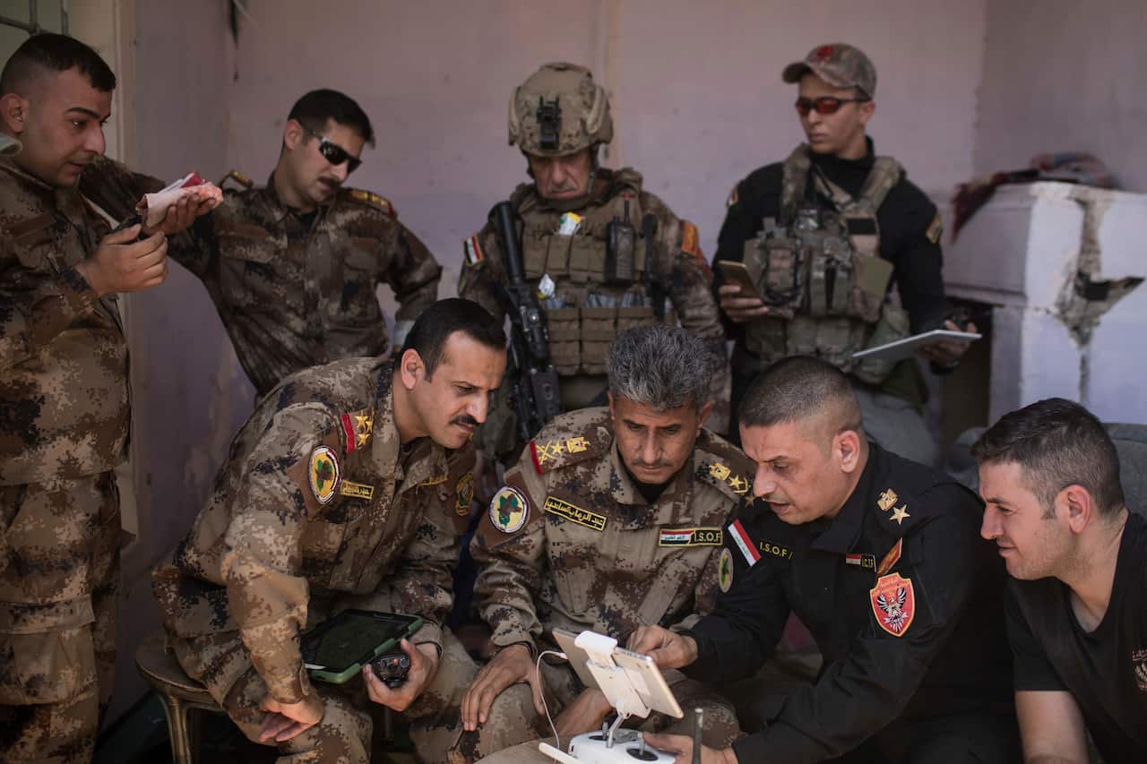 Lt. Gen. Abdul-Wahab al-Saadi, front center, and his team monitor Islamic State positions in the Old City of Mosul, Iraq.