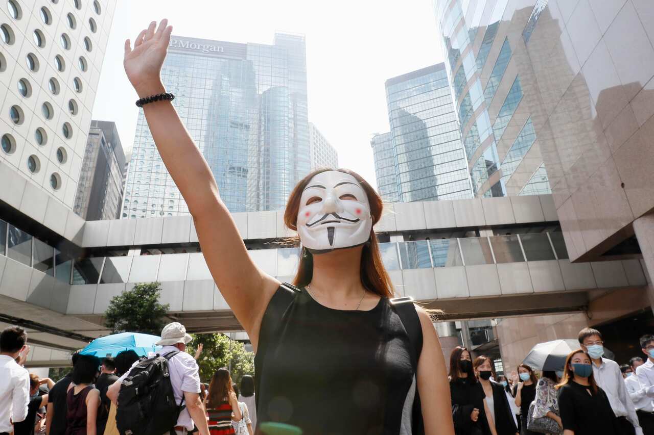A woman takes part in a rally in Hong Kong on Oct. 4, 2019, in protest over the Hong Kong government's invoking of an emergency law to ban protesters from wearing face masks. (Kyodo via AP Images) ==Kyodo