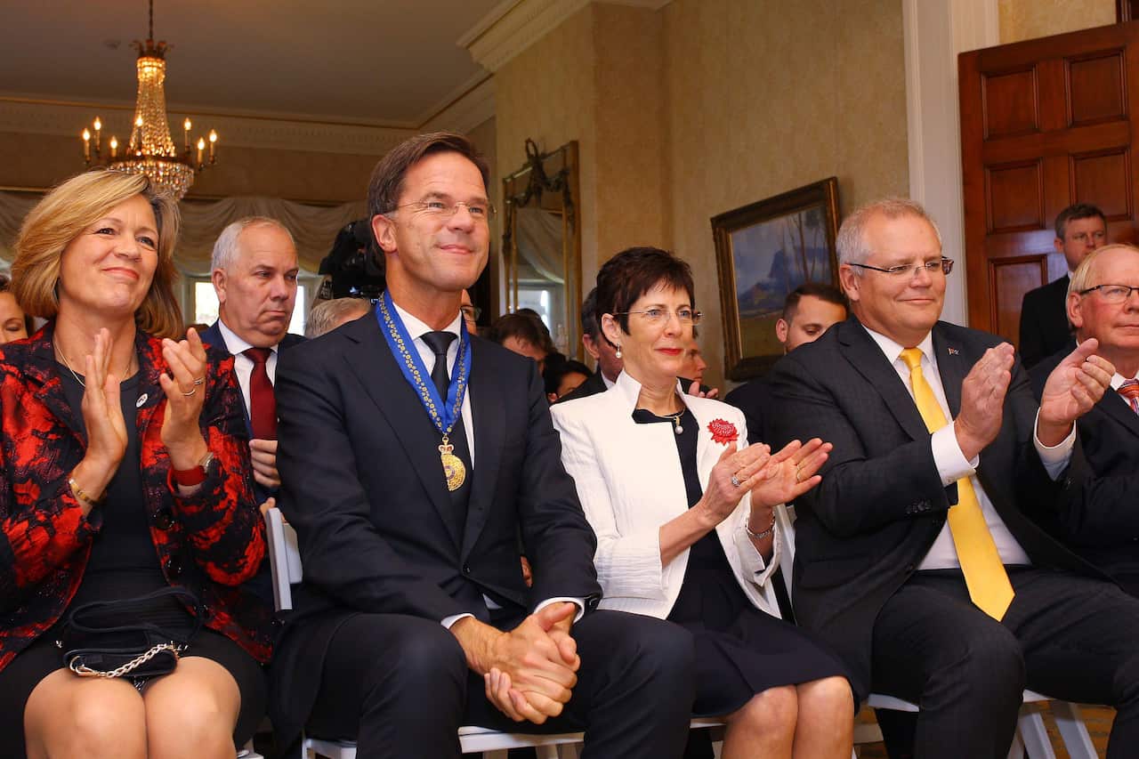 Prime Minister Mark Rutte of the Netherlands sits alongside Linda Hurley and Scott Morrison where he received an 'Honorary Companion of the Order of Australia'
