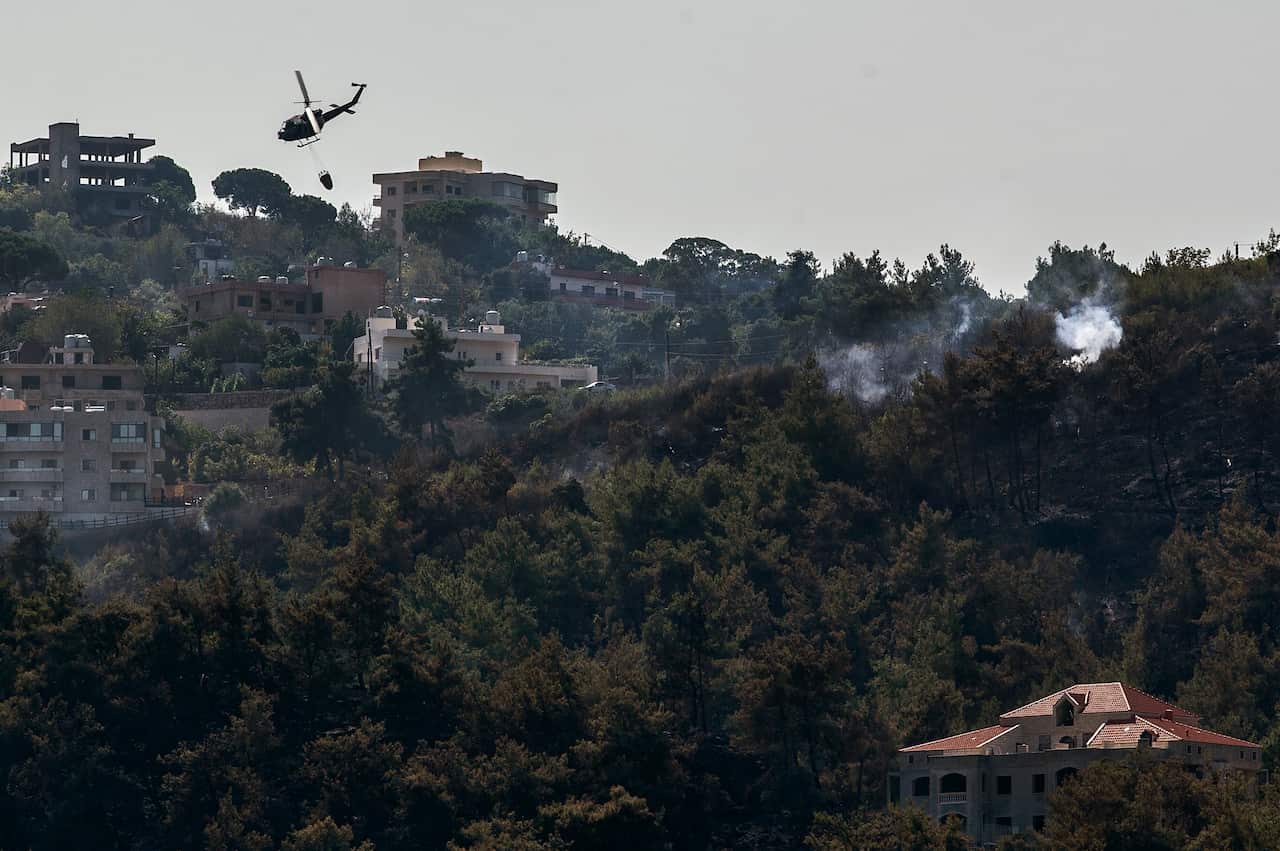A view shows Lebanese Army helicopters fighting the fires to extinguish in Mazraet Al-Daher village in Chouf mountain, south-east Beirut