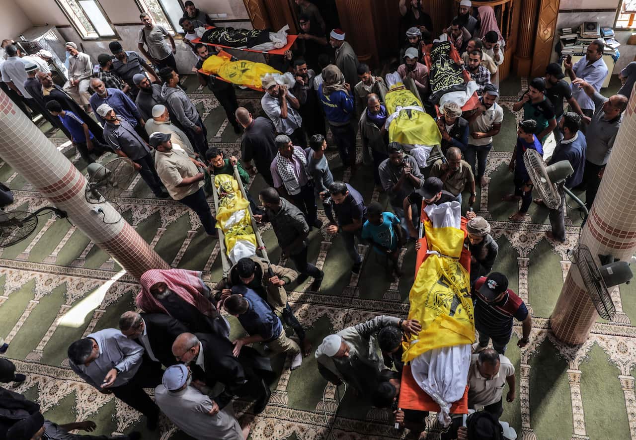 Palestinians carry the bodies of members of Islamic Jihad rocket chief Rasmi Abu Malhous family during their funeral in Deir al-Balah town, 14 November 2019.