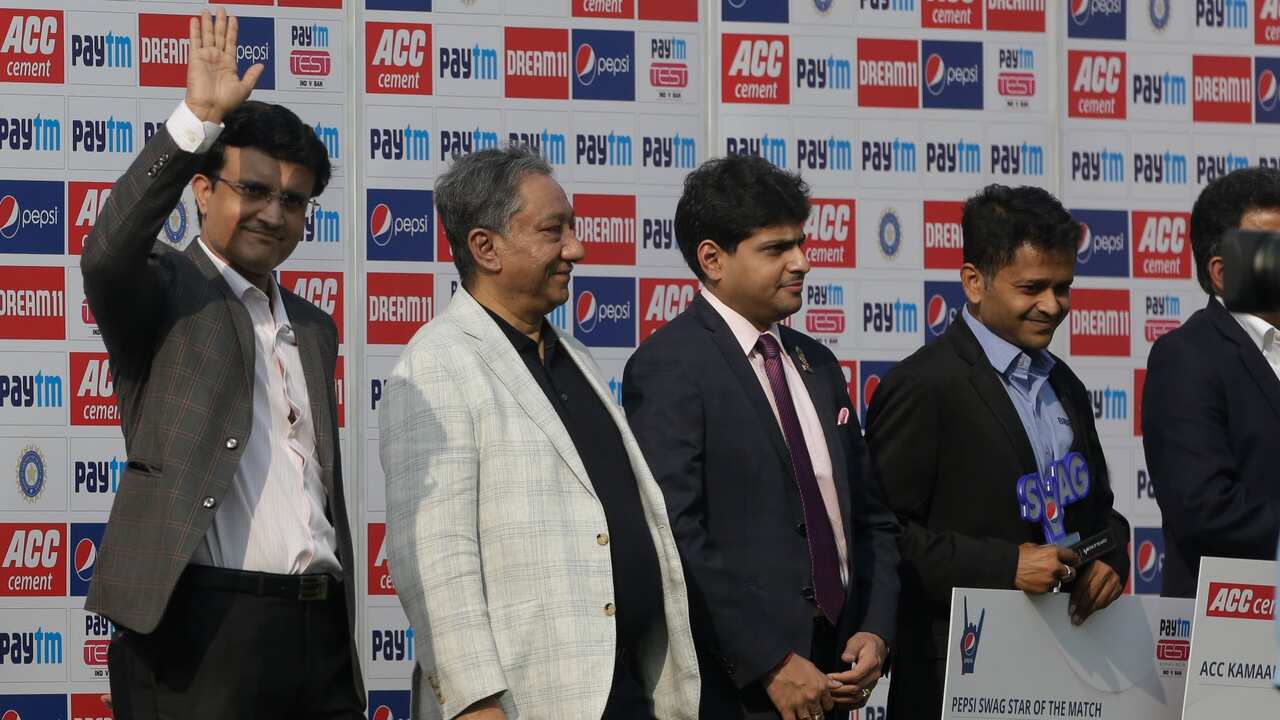 Sourav Ganguly, left, President of Indian Cricket Board waives to crowd as he stand beside his Bangladesh counterpart Nazmu Hossain, second left, Nov. 24, 2019.