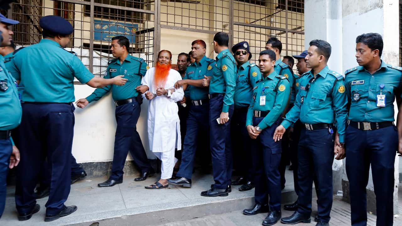 Bangladeshi police escort a person (C), who is accuse of being involved in an attack on the Holey Artisan Bakery.