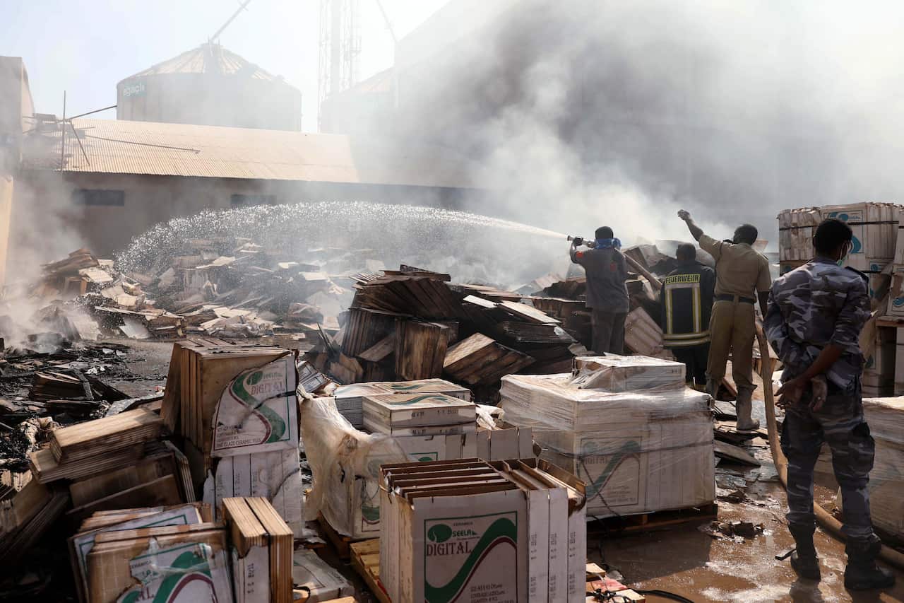 Firefighters work at the scene of fire at a tile manufacturing unit in an industrial zone, north Khartoum, Sudan, 03 December 2019.