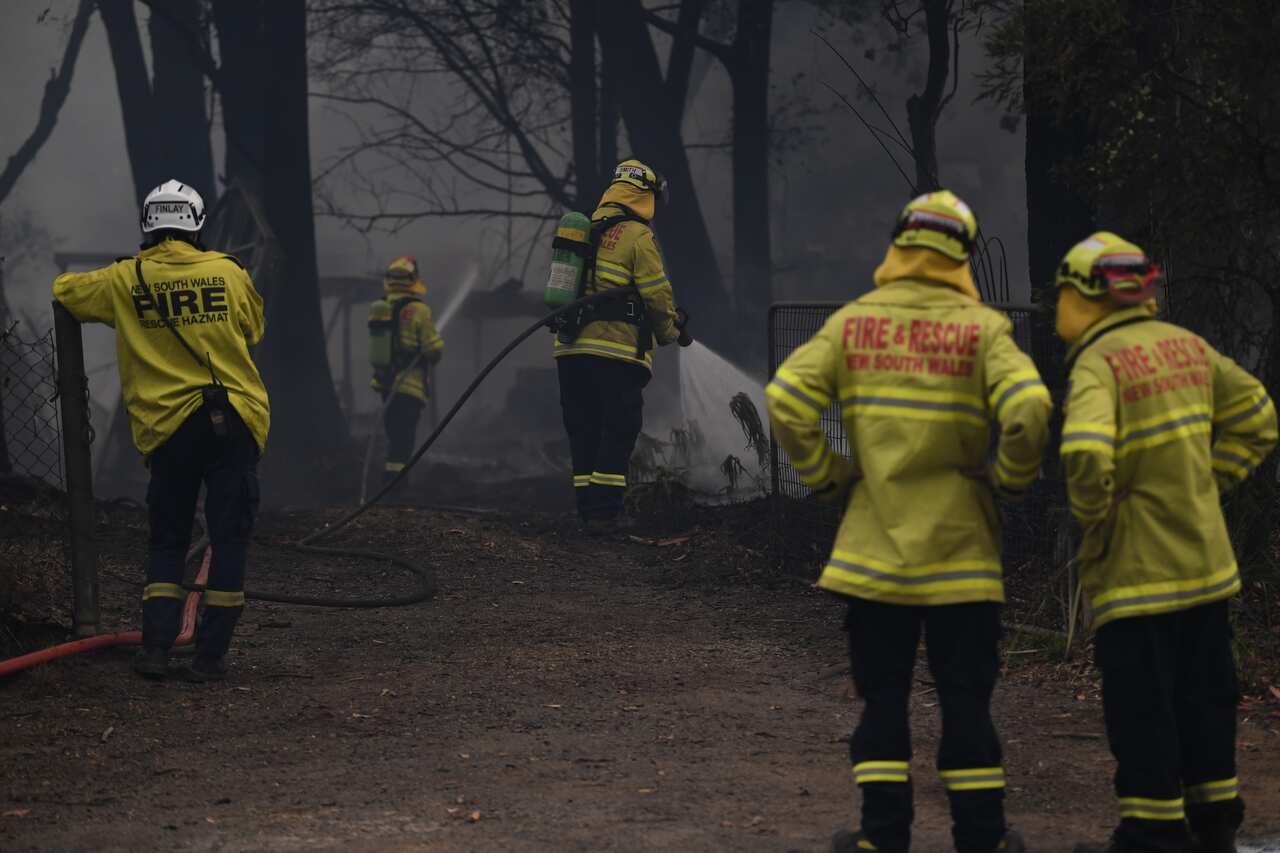 Fire and Rescue NSW fire fighters extinguish a structural fire at a property on Orion Place in Lake Tabourie on the Princes Highway between Batemans Bay