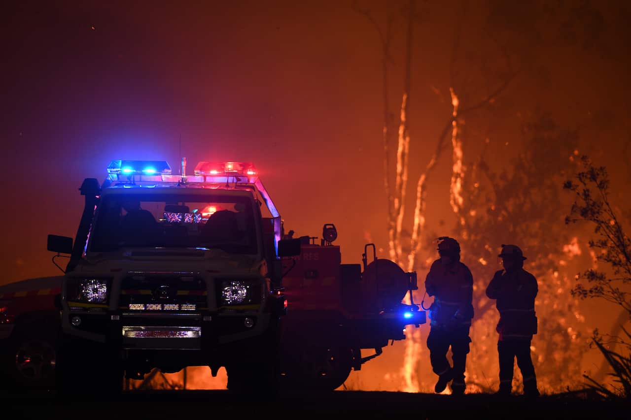 NSW Rural Fire Service crews protect properties on Waratah Road and Kelyknack Road as the Three Mile fire approaches Mangrove Mountain north of Sydney