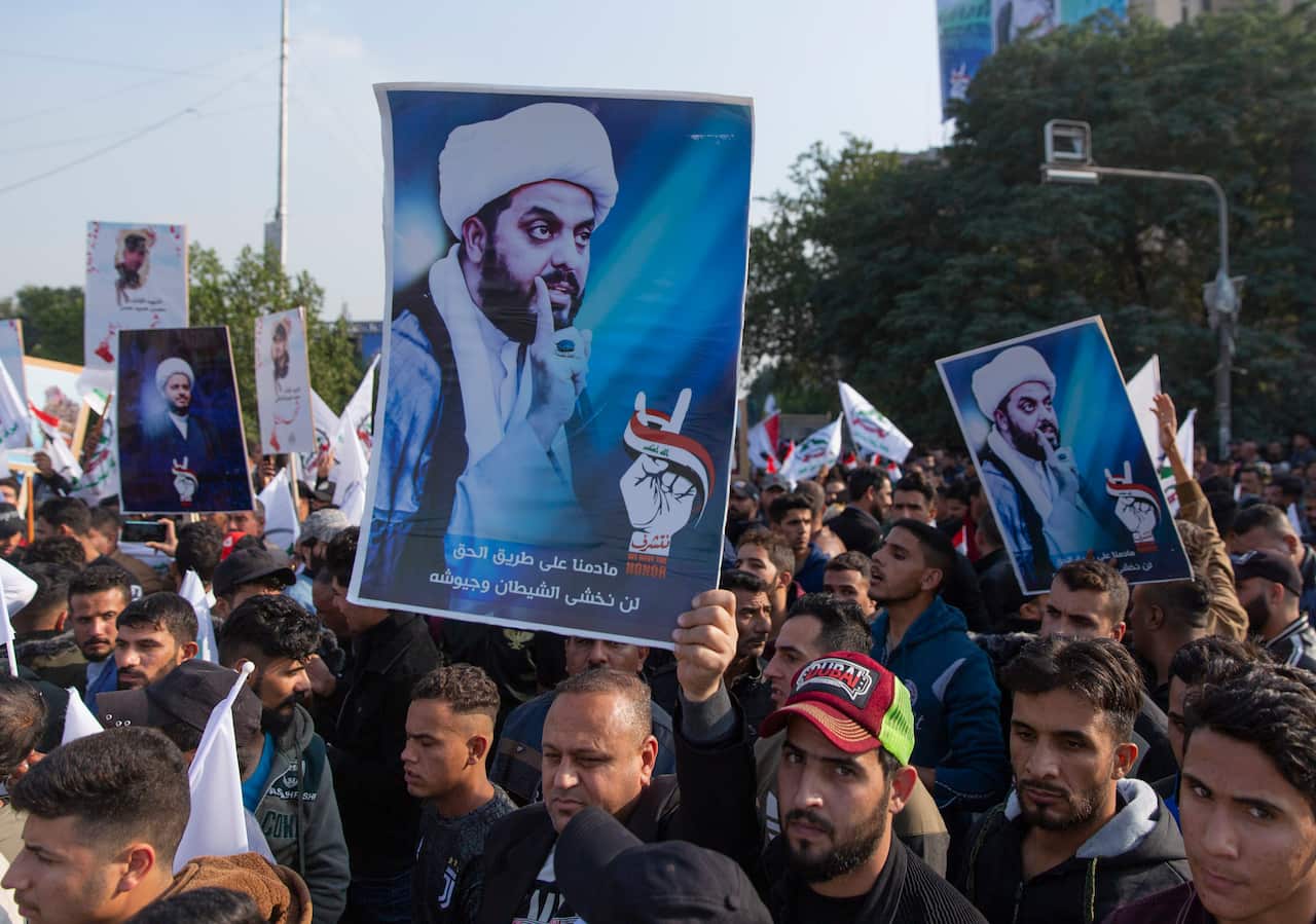 Protesters chant anti US slogans and carry posters with pictures of Qais al-Khazali 