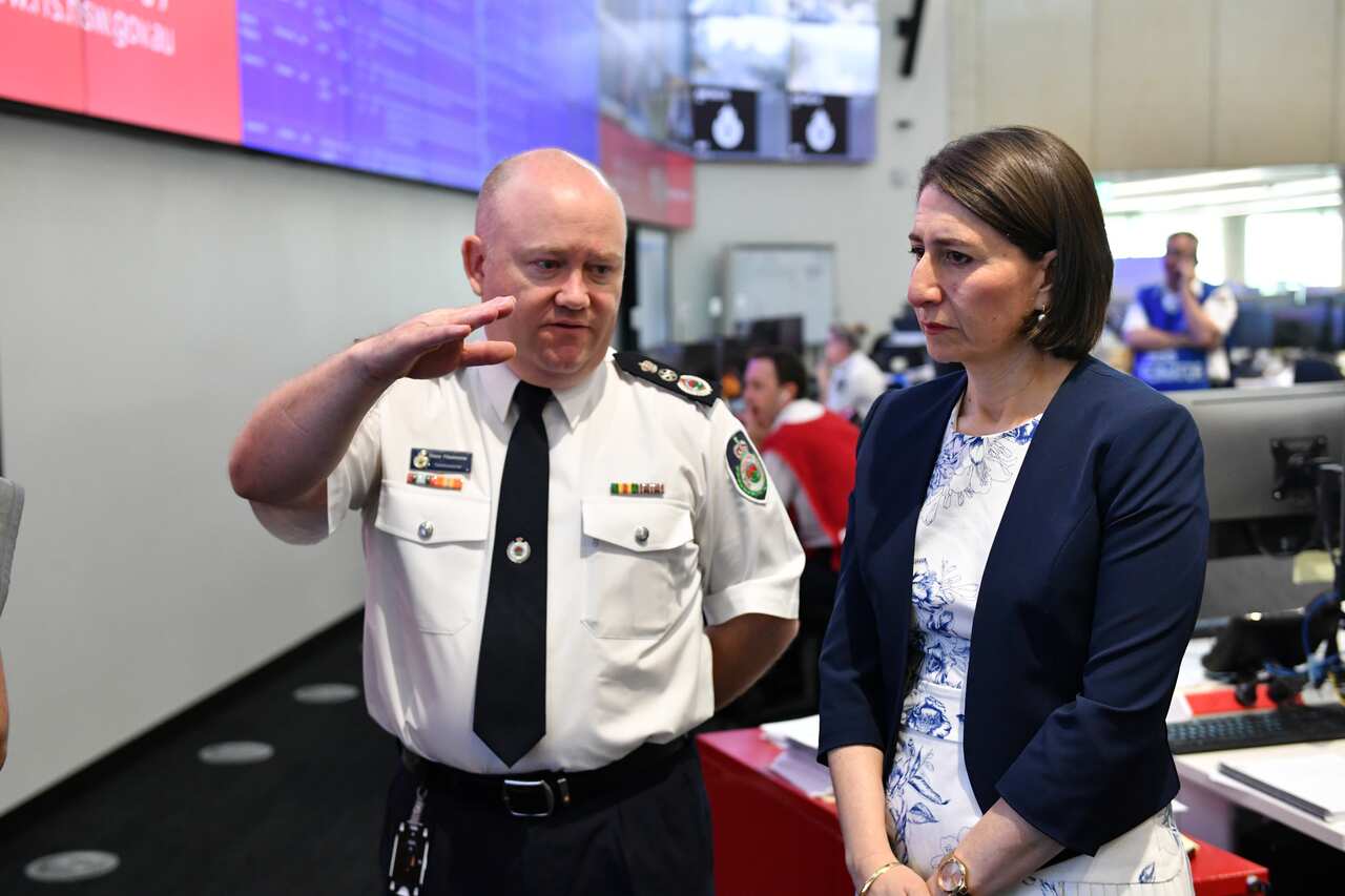 NSW Rural Fire Service Commissioner Shane Fitzsimmons briefs Premier Gladys Berejiklian at the Rural Fire Service headquarters in Sydney, Wednesday, December 18, 2019. (AAP Image/Mick Tsikas) NO ARCHIVING