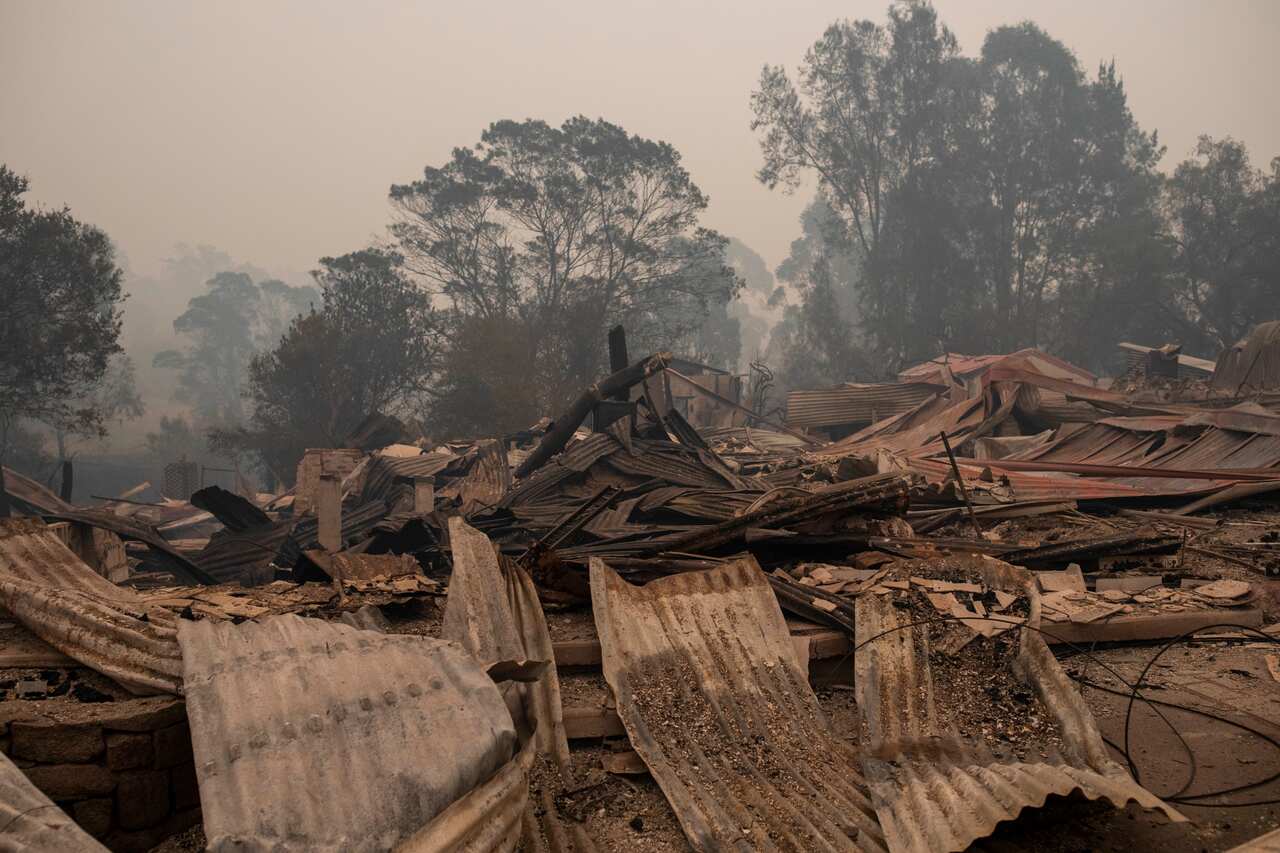 Destroyed buildings are seen in Cobargo, NSW, Wednesday, January 1, 2020. Several bushfire-ravaged communities in NSW have greeted the new year under immediate threat. (AAP Image/Sean Davey) NO ARCHIVING