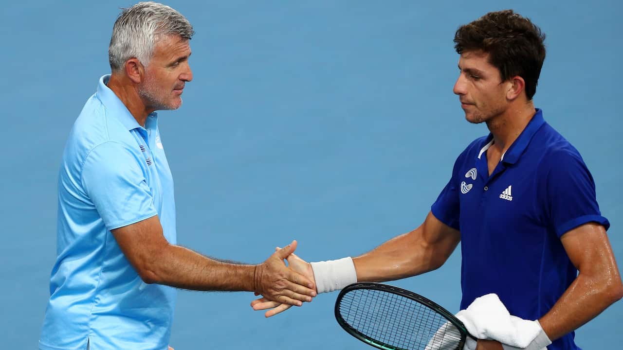 Michalis Pervolarakis (R) shakes hands with his Greek team captain Apostolos Tsitsipas. 