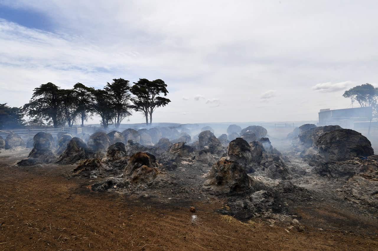 Smoke rises from burning hay bales on Kangaroo Island, southwest of Adelaide, Friday, January 10, 2020. Nearly half of the Island has now be burnt by bushfires, some of them uncontrolled. (AAP Image/David Mariuz) NO ARCHIVING