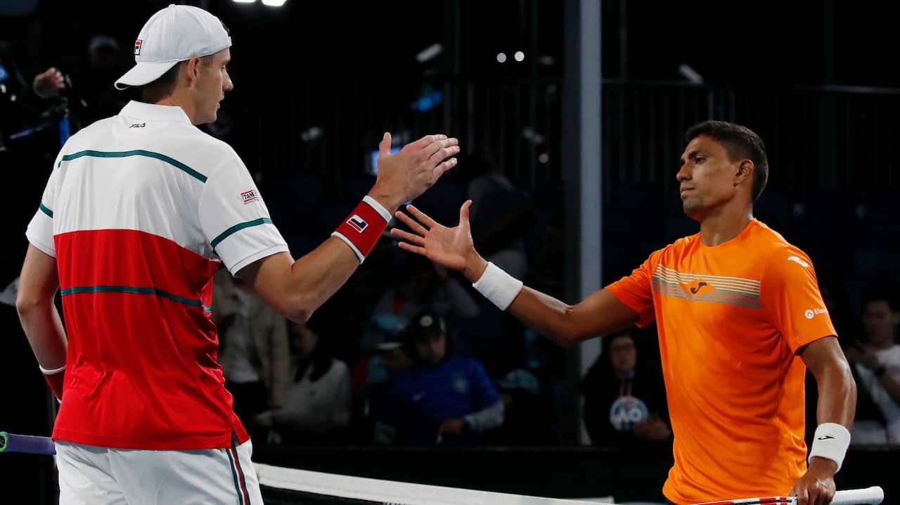 epa08147459 John Isner (L) of USA and Thiago Monteiro (R) of Brazil meet at the net after their men's singles first round match at the Australian Open Grand Slam tennis tournament in Melbourne, Australia, 22 January 2020. EPA/FRANCIS MALASIG
