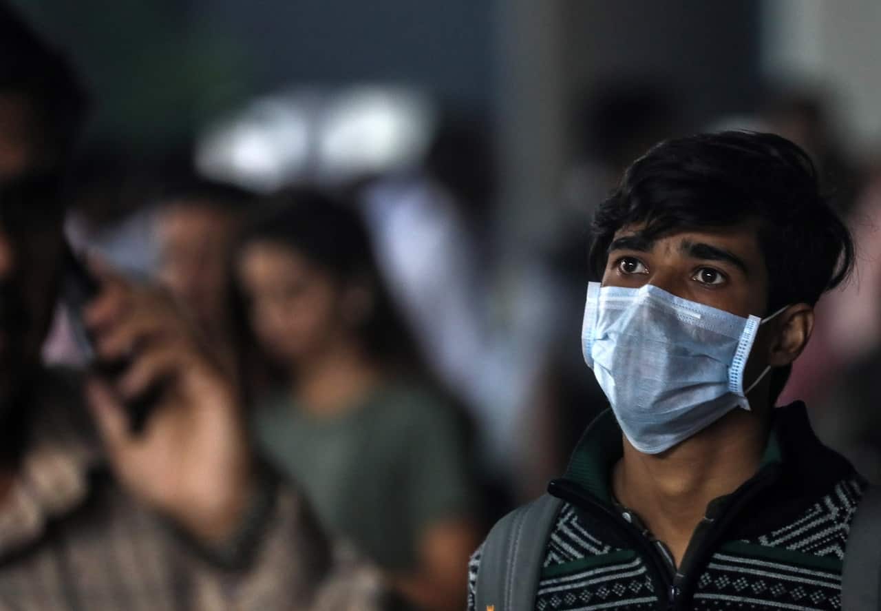 A passenger wears a protective face mask on arrival at Chhatrapati Shivaji Maharaj International Airport, in Mumbai, India, 03 February 2020.