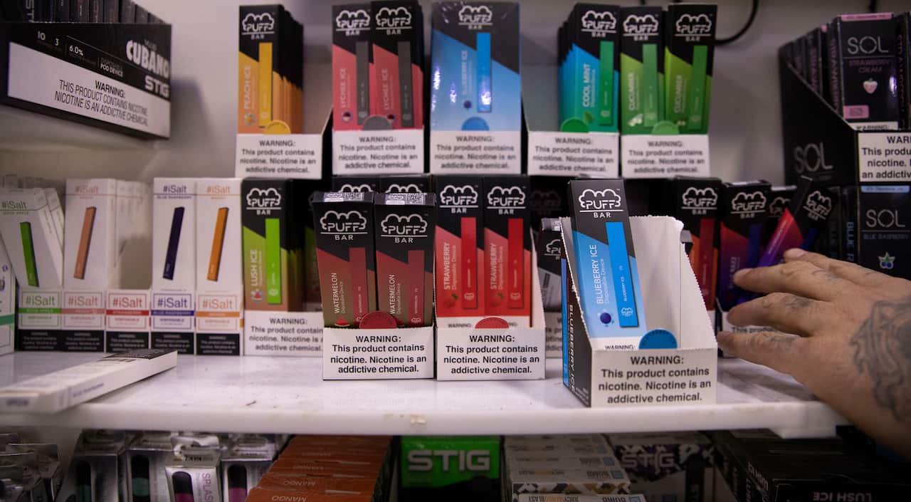 This Jan. 31, 2020 photo shows various brands and flavors of disposable vape devices at a store in the Brooklyn borough of New York. (AP Photo/Marshall Ritzel)