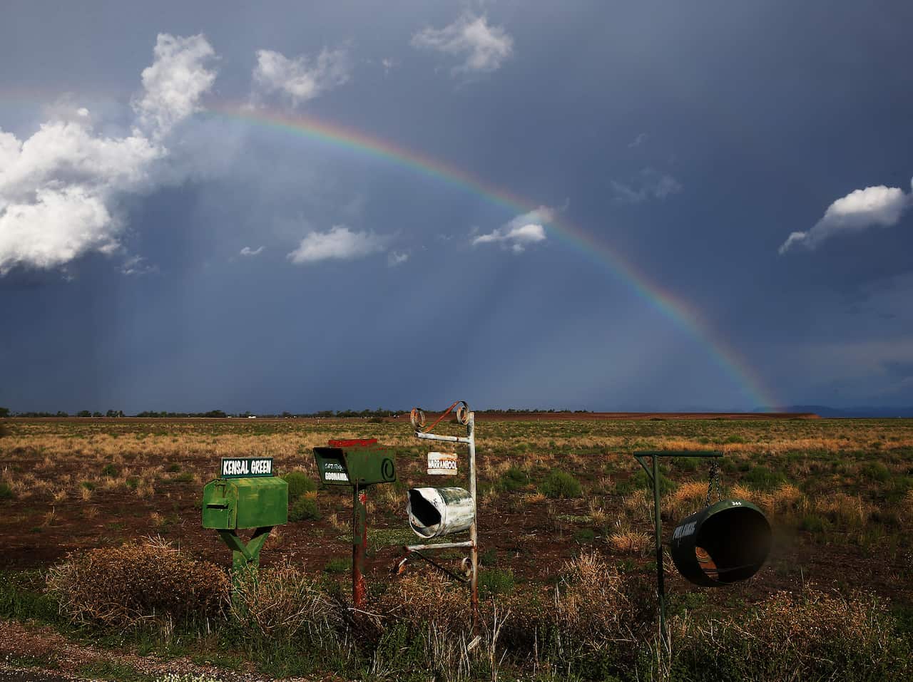 A rainbow appears behind a storm front on the Breeza Plains in north west NSW. Residents in parts of NSW continue to face floodwater risks after a weekend of torrential downfalls. (AAP Image/ Peter Lorimer) NO ARCHIVING
