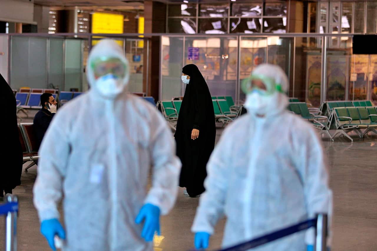 Medical staff prepare to check passengers arriving from Iran in the airport in Najaf, Iraq, Friday, Feb. 21, 2020. 