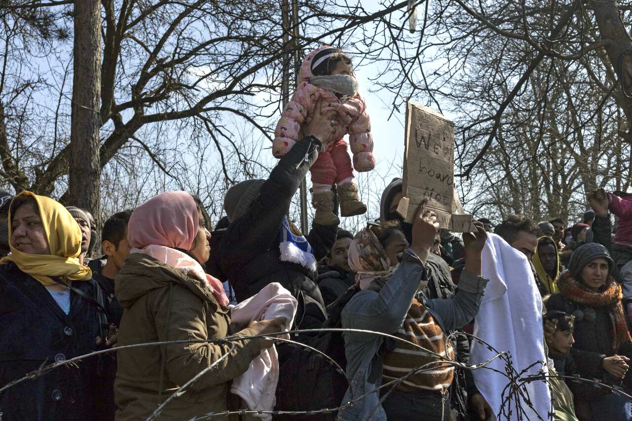 Refugees wait in front of the Greek border at Pazarkule gate, in Edirne, Turkey, on March 01, 2020. 