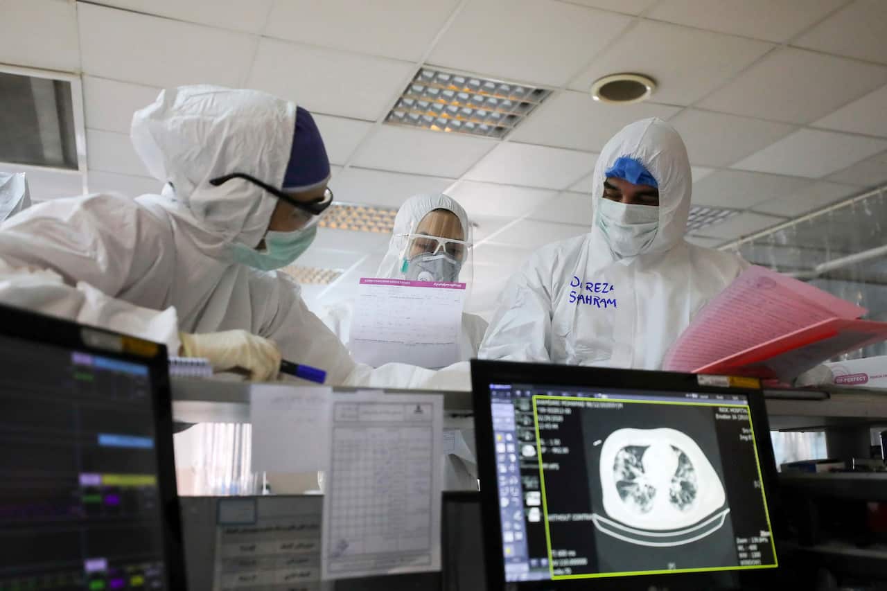 medics wearing protective gear work in a quarantined ward for coronavirus infected patients, at a hospital in Tehran, Iran.
