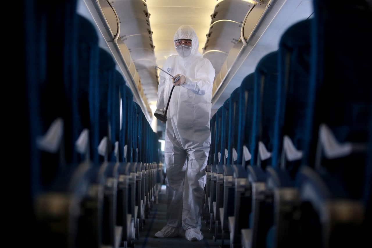 A worker sprays disinfectant as a precaution against coronavirus