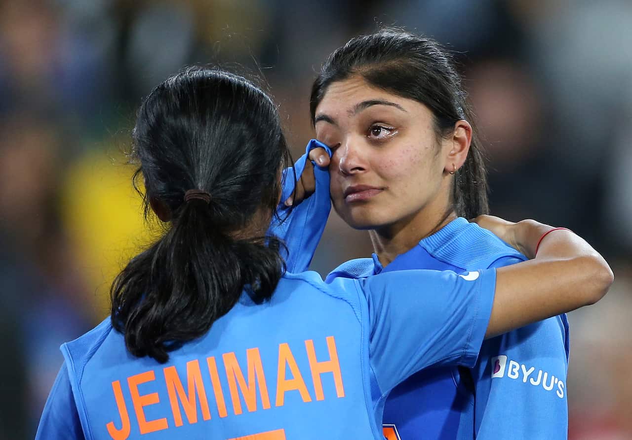 India's Jemimah Rodrigues, left, comforts Smriti Mandhana after their team's loss to Australia in the Women's T20 World Cup cricket final match in Melbourne, Sunday, March 8, 2020. (AP Photo/Asanka Ratnayake)