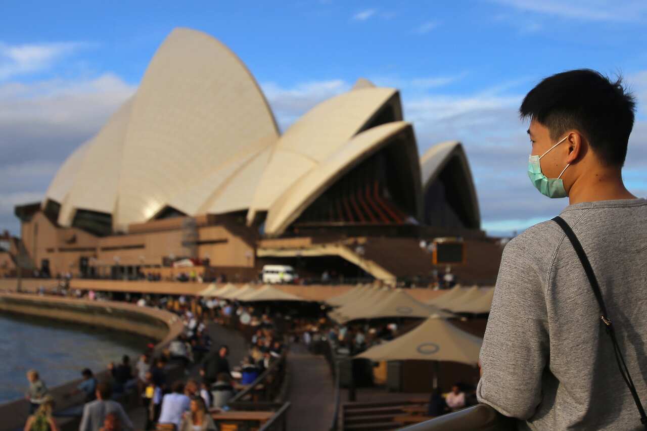 People wear face masks at the Sydney Opera House in Sydney.