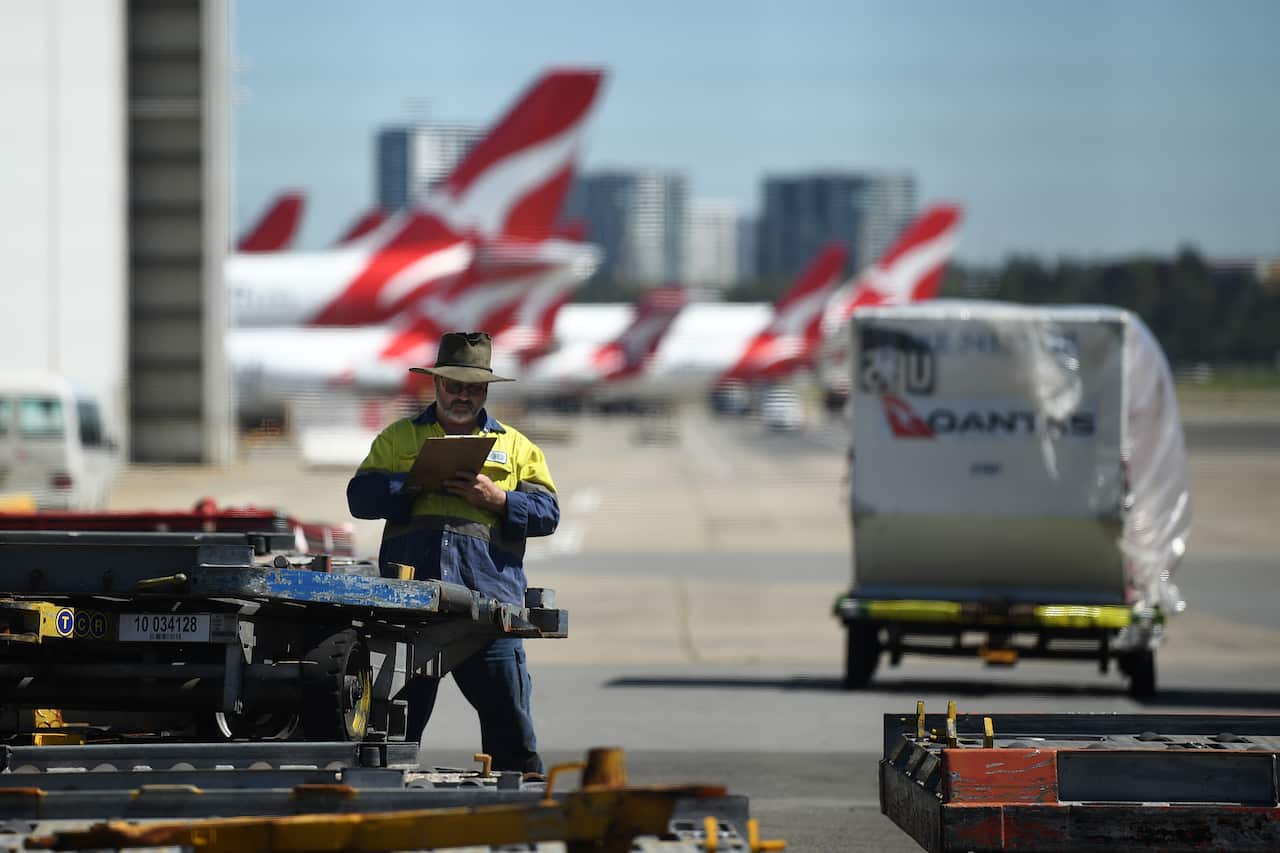 Qantas aircraft a Sydney Airport in Sydney, Thursday, March 19, 2020. Qantas has announced mandatory vaccination for its staff
