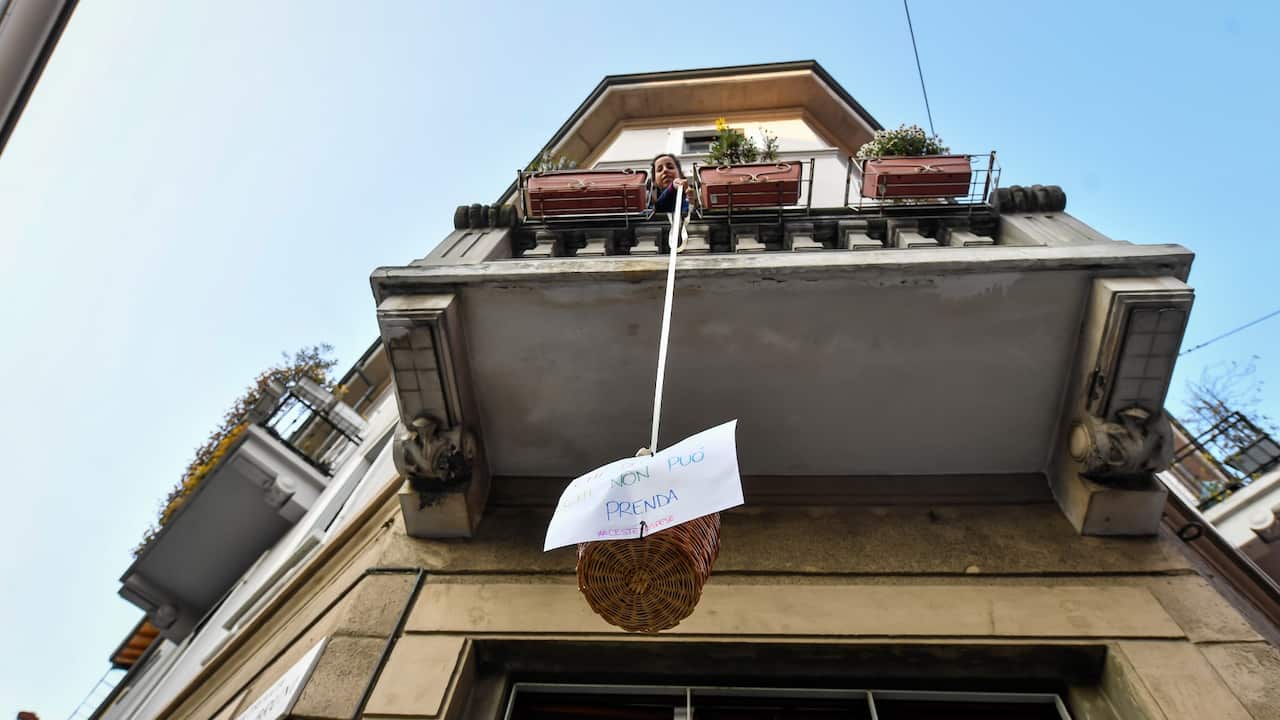 Baskets hanging on the balconies with basic necessities to help the needy during the coronavirus emergency in Milan, Italy on April 4, 2020.