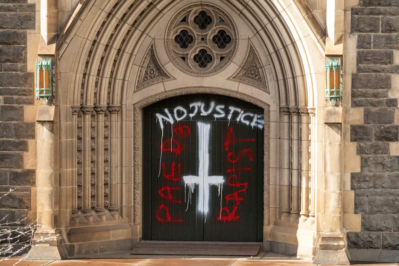 Graffiti is seen at St Patricks Cathedral in Melbourne, Australia, Wednesday, April 8, 2020. (AAP Image/Daniel Pockett) NO ARCHIVING