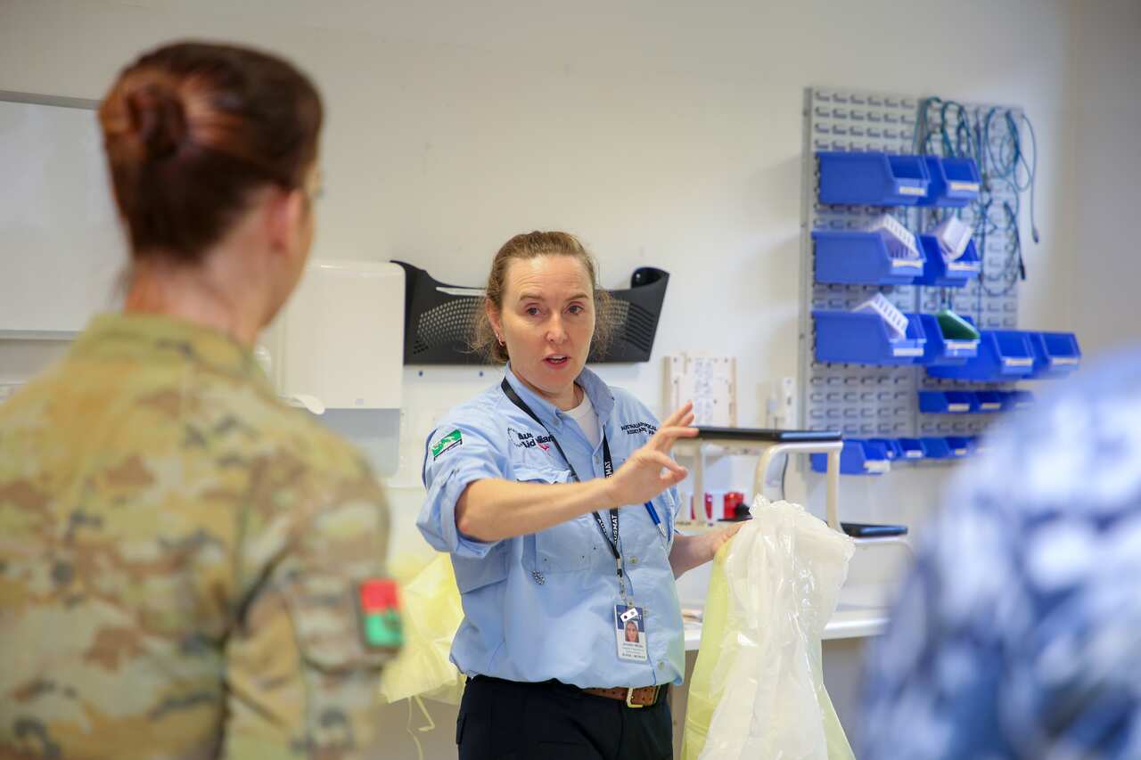 A supplied image obtained on Saturday, April 18, 2020, shows Infection Prevention and Control Advisor, Jennifer White, giving a Personal Protective Equipment briefing to ADF health professionals in the North West Regional Hospital in Burnie, Tasmania, aft