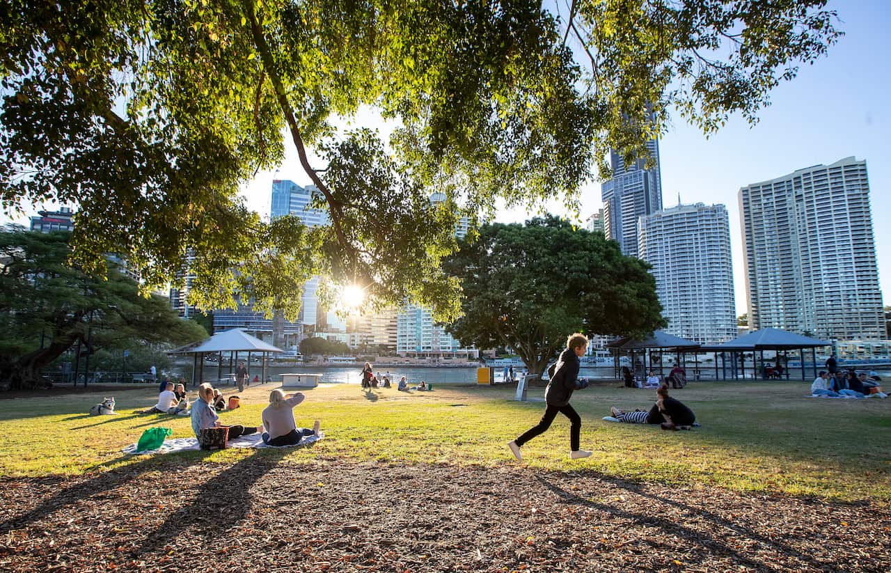Queenslanders are being urged to continue practicing social distancing as some coronavirus measures are rolled back.