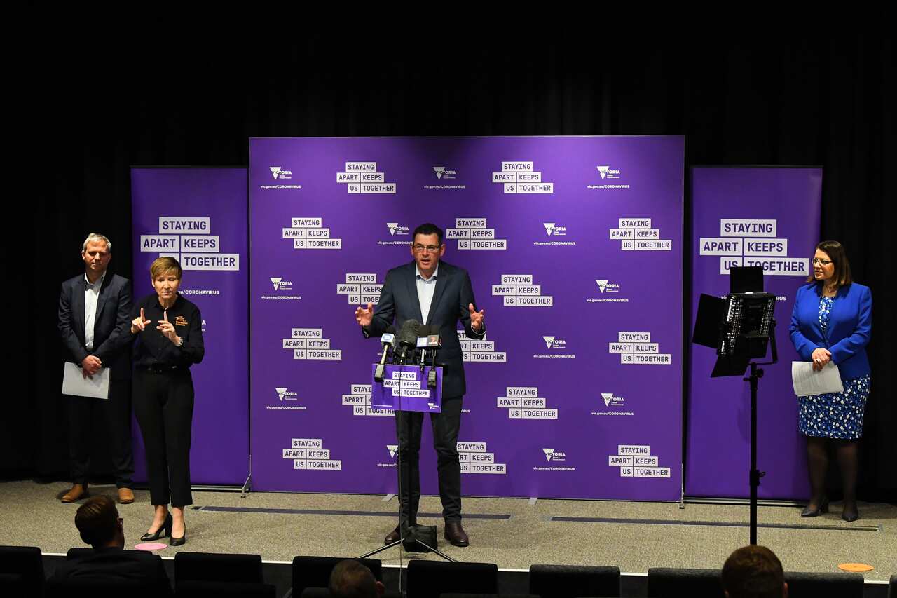 Victorian Premier Daniel Andrews (centre)  during a press conference in Melbourne