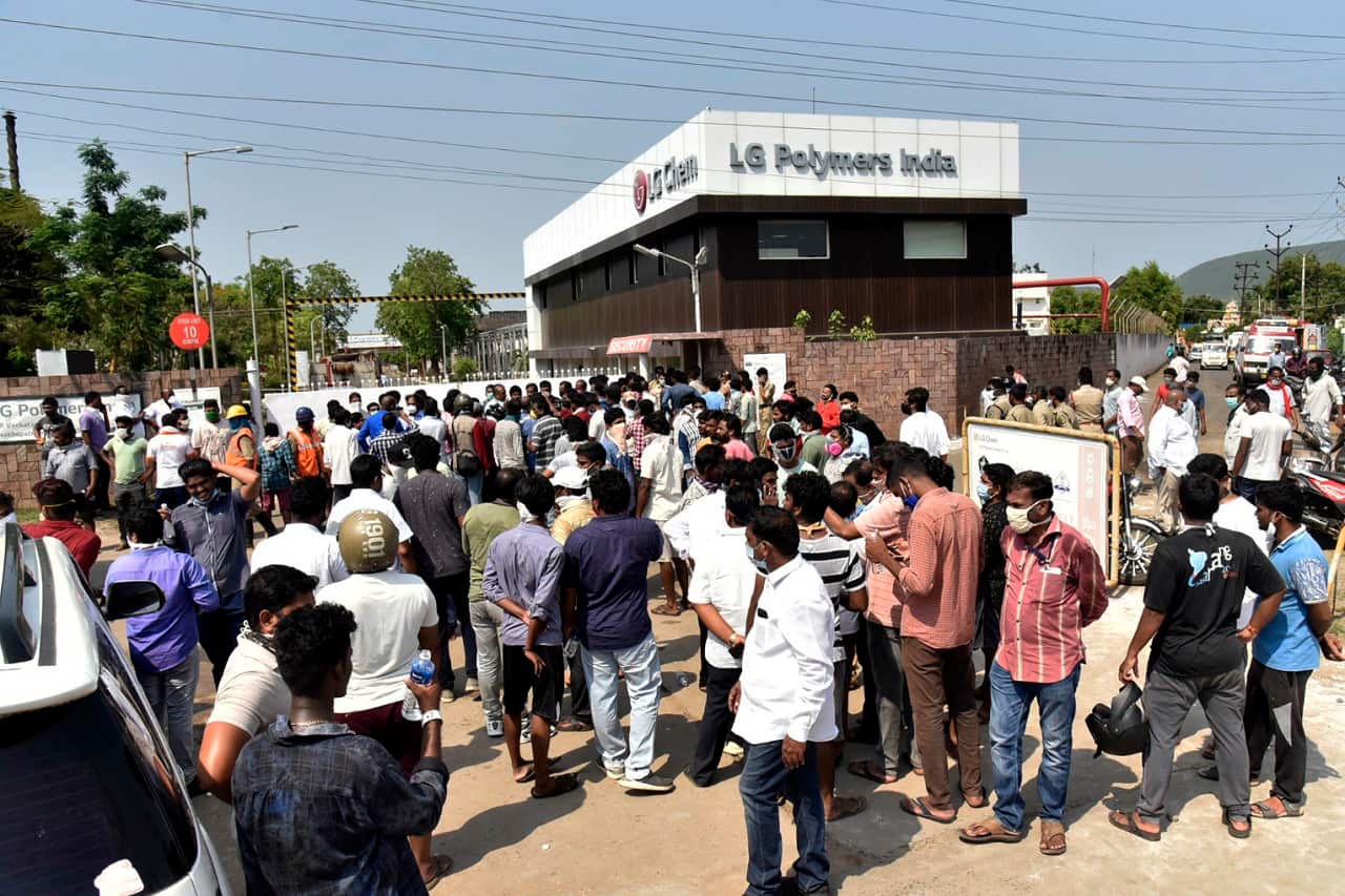 A crowd gathers outside the LG Polymers plant from where chemical gas leaked in Vishakhapatnam, India, Thursday, May 7, 2020.