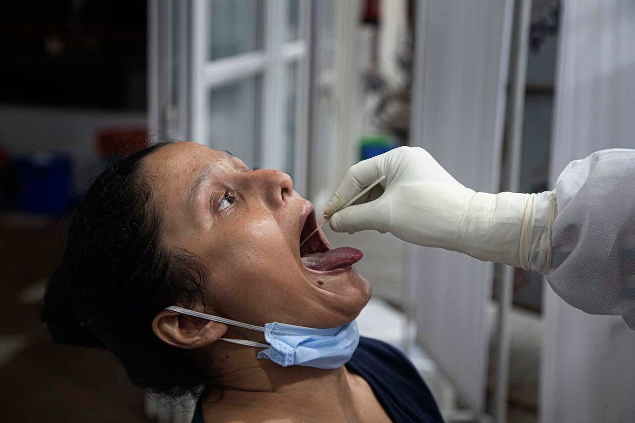 An Indian doctor conducts a swab test for corona virus in Guwahati Medical College Hospital (GMCH) in Gauhati, India, Sunday, May 17, 2020.