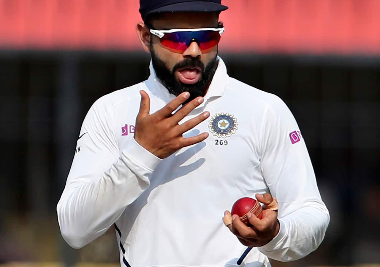 In this Nov. 16, 2019, file photo India's captain Virat Kohli shines the ball during their cricket test match against Bangladesh in Indore, India.