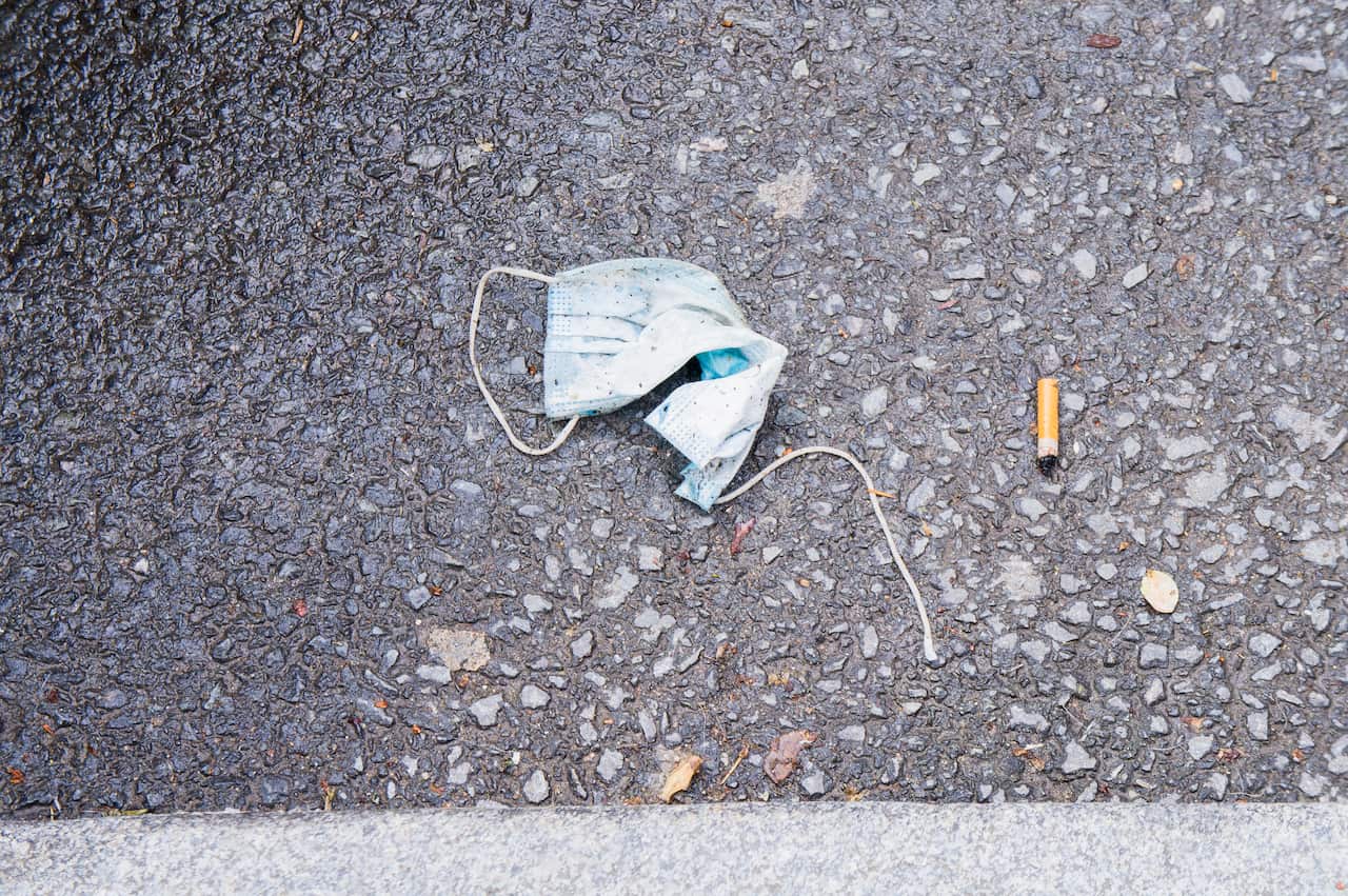 discarded face mask lies on the ground, pandemic, coronavirus, hazardous waste, fag end, cigarette stub, May 24, 2020. Photo/Libor Sojka (CTK via AP Images)